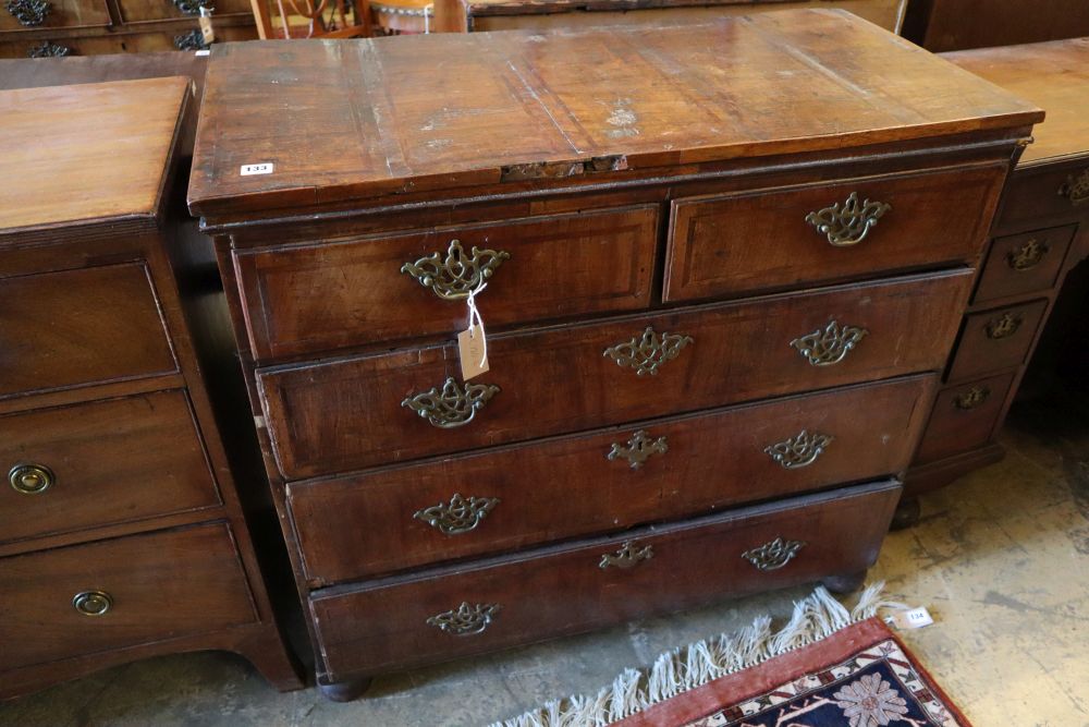 An early to mid 18th century chest with later top, two short and three long drawers, on later bun feet, width 101cm
